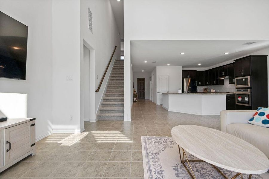 Living room featuring recessed lighting and light tile patterned floors Living room featuring recessed lighting and light tile patterned floors