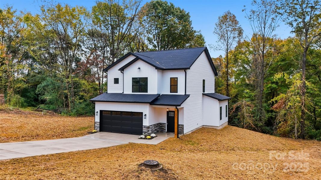 Front exterior of a new home in , Mount Holly, NC, highlighting curb appeal (Image 1). Front exterior of a new home in , Mount Holly, NC, highlighting curb appeal (Image 1).