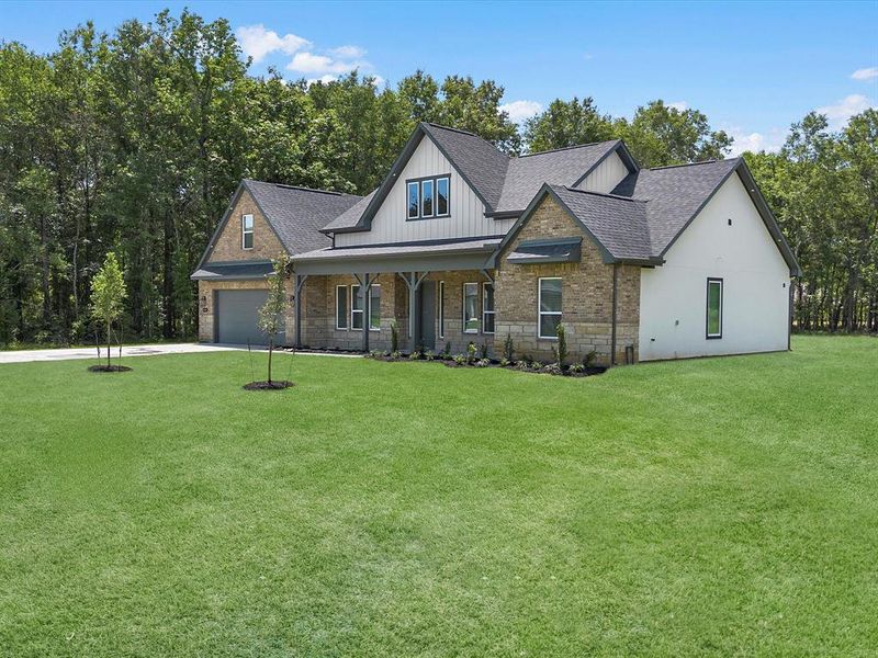 Front exterior of a new home in , Dayton, TX, highlighting curb appeal (Image 22).