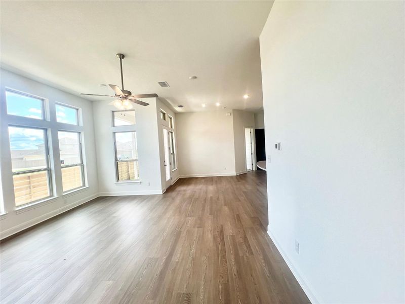 Empty room with dark wood-type flooring, recessed lighting, and ceiling fan Empty room with dark wood-type flooring, recessed lighting, and ceiling fan