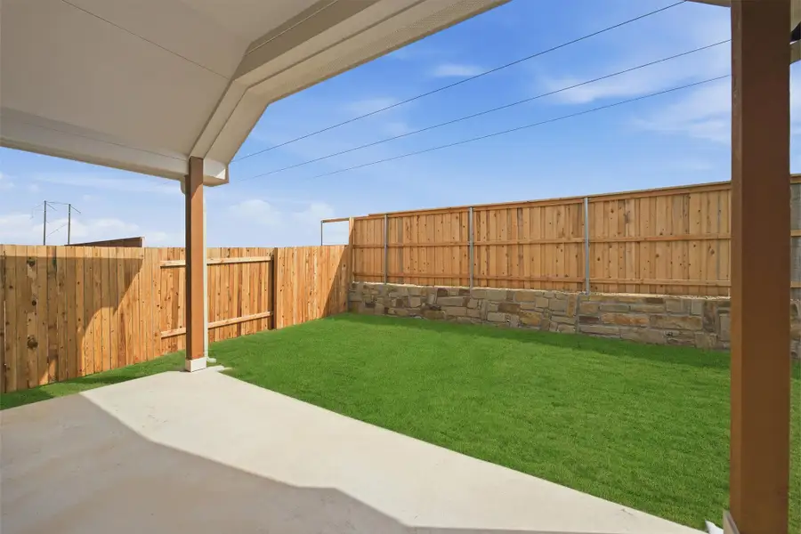 Fenced backyard with a patio area