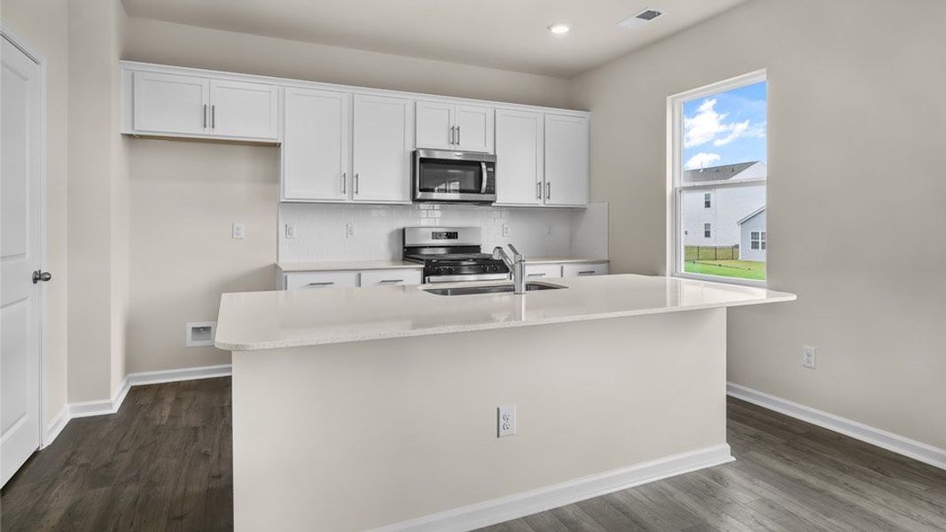 Representative furnished interior of a home built from the BELHAVEN by D.R. Horton in Galvins Ridge, Sanford (Image 4).
