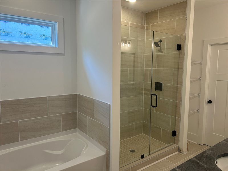 This bathroom features a contemporary shower and a This bathroom features a contemporary shower and a