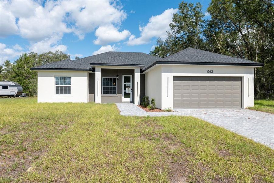 Front exterior of a new home in , Ocala, FL, highlighting curb appeal (Image 1). Front exterior of a new home in , Ocala, FL, highlighting curb appeal (Image 1).