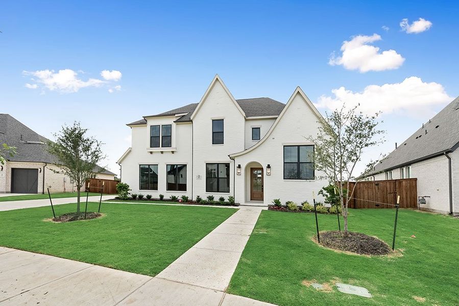 Front exterior of a new home in Light Farms Graham/Reagan, Celina, TX, highlighting curb appeal (Image 2). Front exterior of a new home in Light Farms Graham/Reagan, Celina, TX, highlighting curb appeal (Image 2).