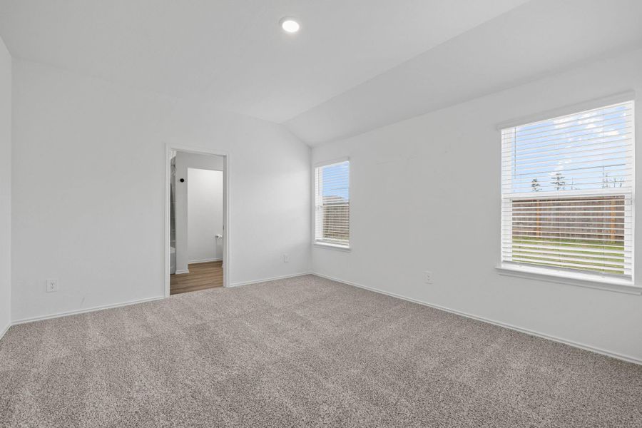 Primary bedroom with two windows facing a backyard and no rear neighbors!