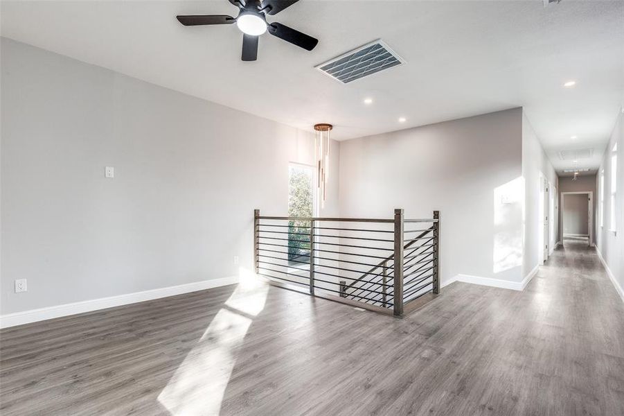 Unfurnished room with wood-type flooring and ceiling fan