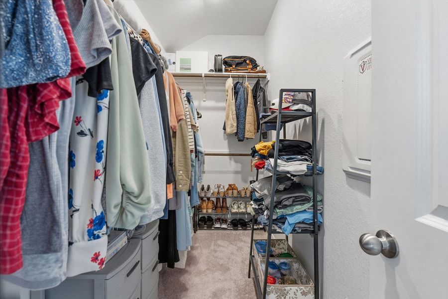 Walk in closet featuring light colored carpet Walk in closet featuring light colored carpet