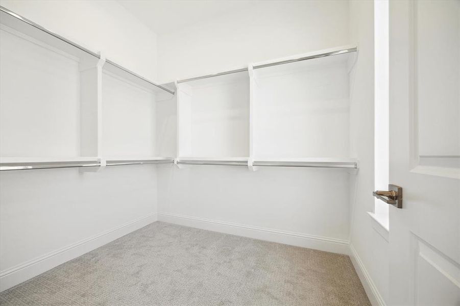 Second primary closet with built in window for natural light.