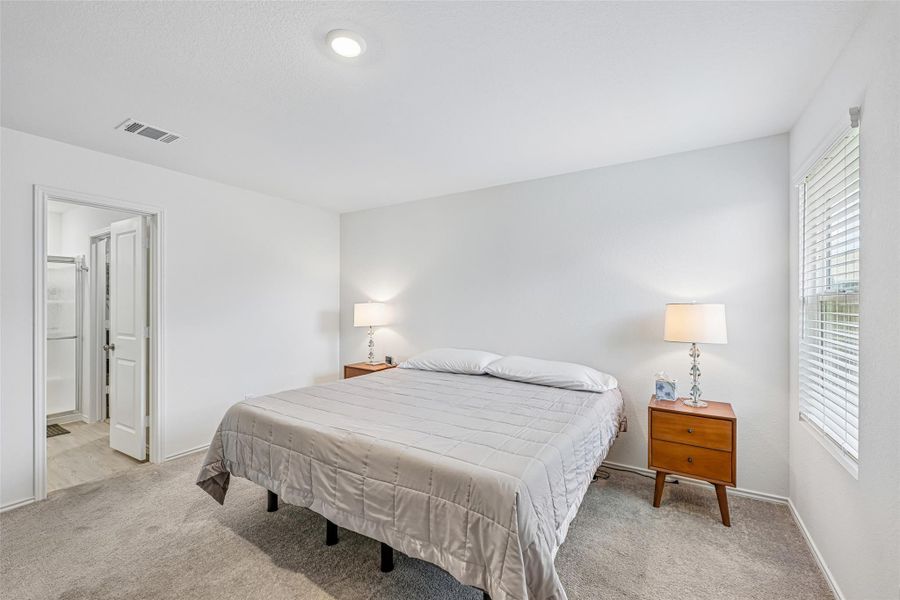 Carpeted bedroom featuring white walls and a recessed ceiling light Carpeted bedroom featuring white walls and a recessed ceiling light