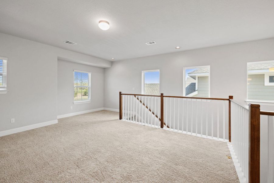 Carpeted spare room featuring baseboards, visible vents, and recessed lighting Carpeted spare room featuring baseboards, visible vents, and recessed lighting