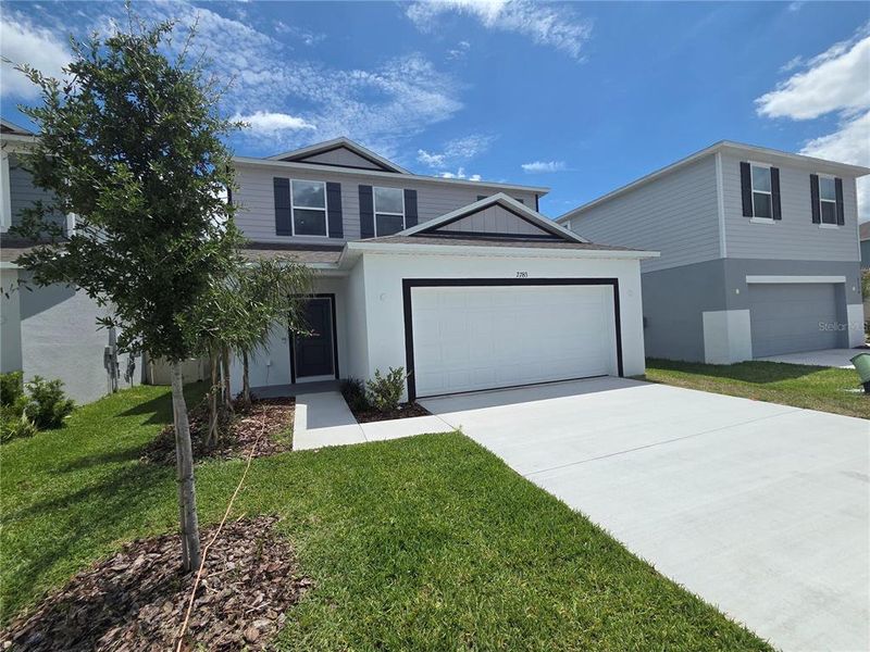 Front exterior of a new home in Villamar, Winter Haven, FL, highlighting curb appeal (Image 21).