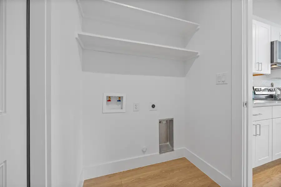 Functional laundry nook provides ample space for appliances and storage. Functional laundry nook provides ample space for appliances and storage.
