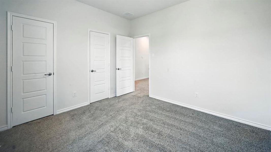 Unfurnished bedroom featuring carpet flooring and baseboards