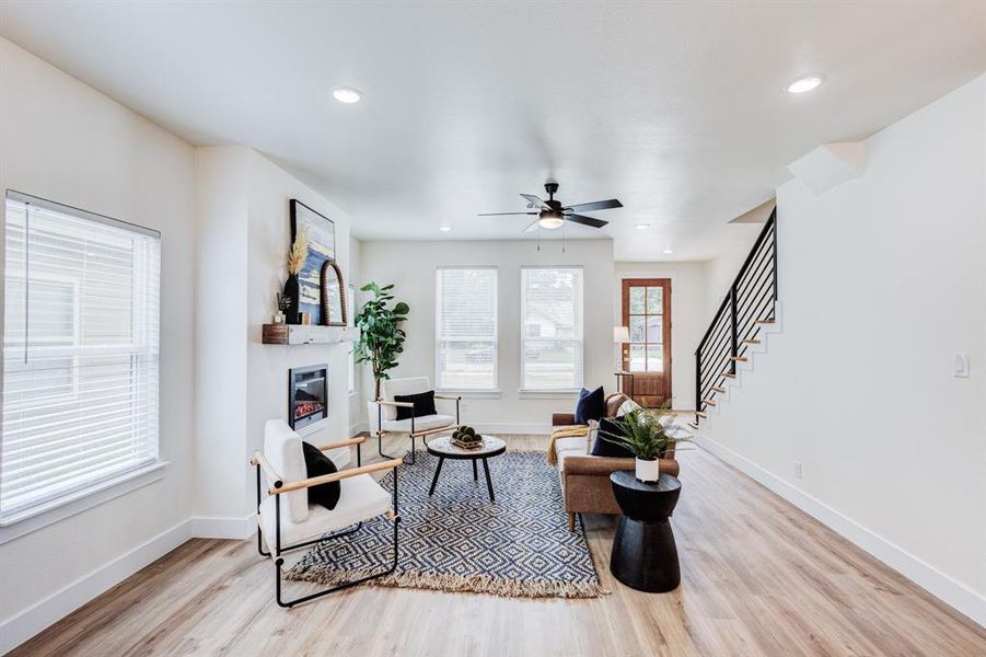 Living room with light wood-type flooring and ceiling fan