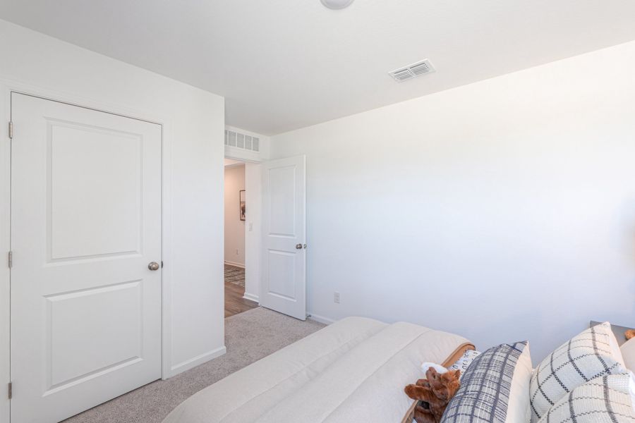 A room with white walls and a couch. A room with white walls and a couch.