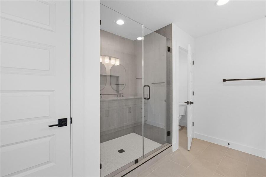 Full bathroom with a stall shower, light tile patterned floors, recessed lighting, and vanity