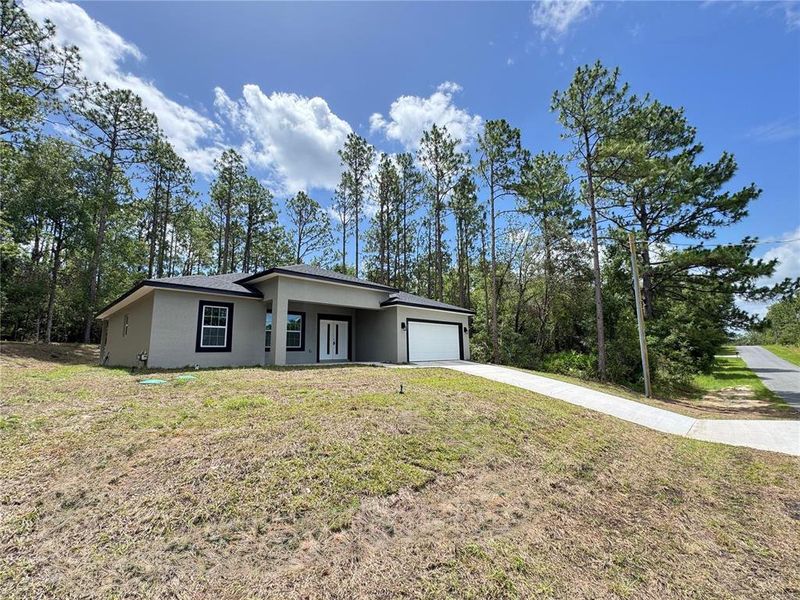 Front exterior of a new home in , Dunnellon, FL, highlighting curb appeal (Image 21).
