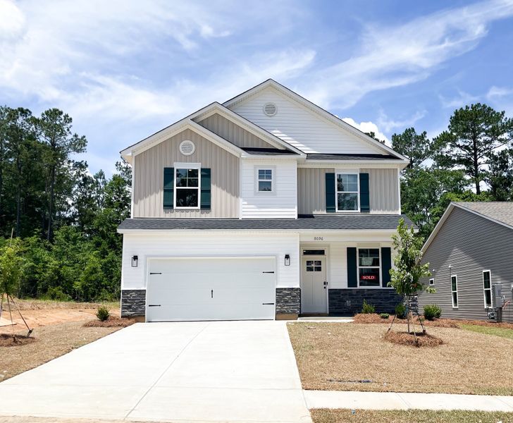 Front exterior of a new home in Essence at Whiskey Run, New Ellenton, SC, highlighting curb appeal (Image 1). Front exterior of a new home in Essence at Whiskey Run, New Ellenton, SC, highlighting curb appeal (Image 1).