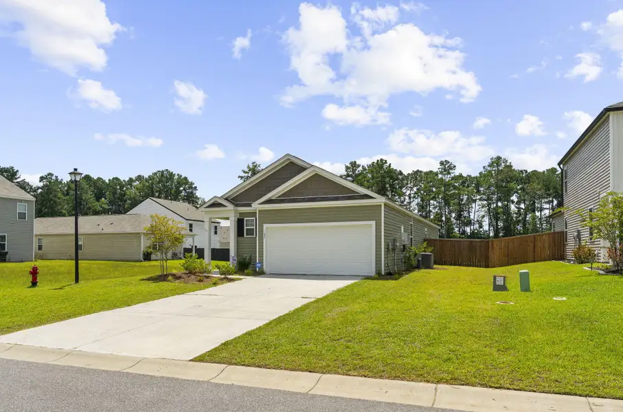 Front exterior of a new home in Pine Hills at Cane Bay, Summerville, SC, highlighting curb appeal (Image 22).