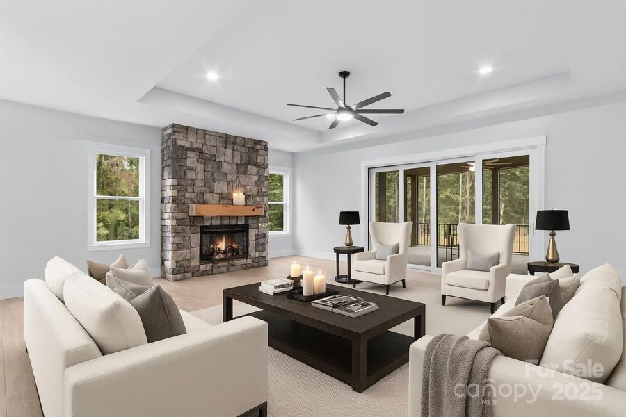 Masterful architectural design like the great room with 11 ft tray ceiling, stone wall with electric fireplace, 8 ft tall sliding doors that open to screened Trex deck & upsale lighting.