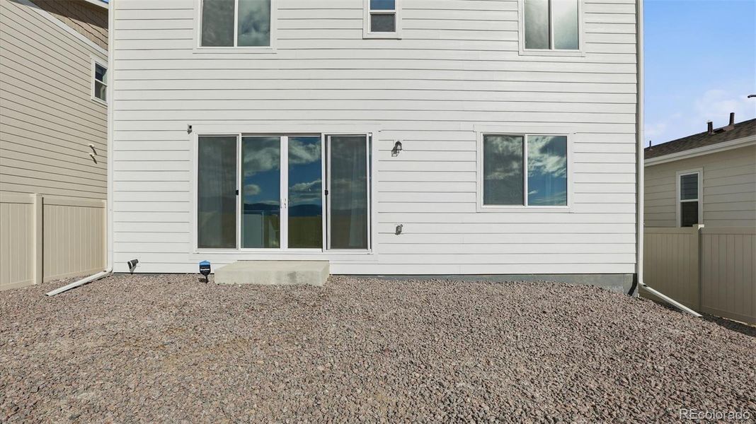 Rear view of backyard and back of structure.