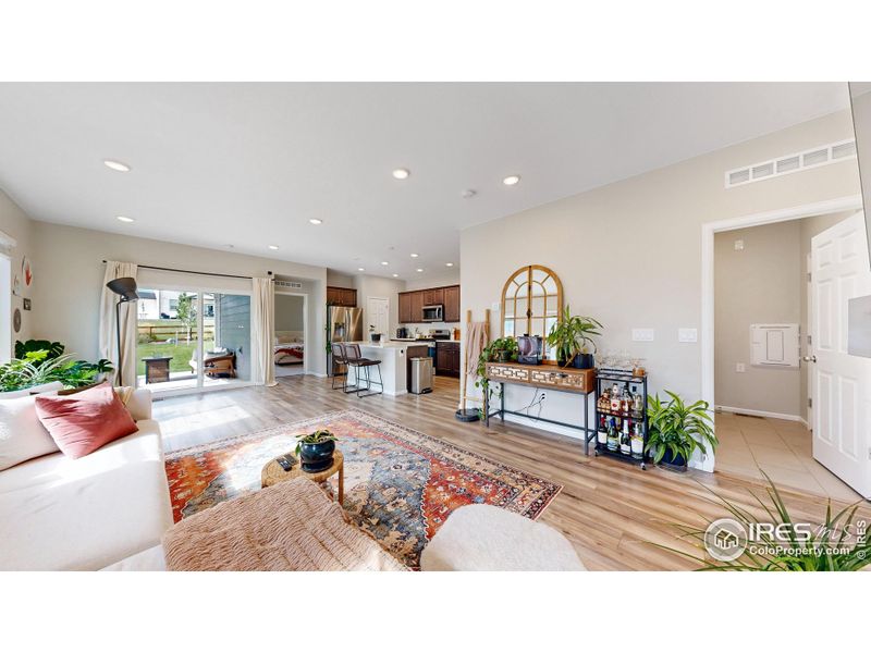 Open concept floor plan featuring LVP flooring, a gas fireplace in the living space and a walk-out patio.