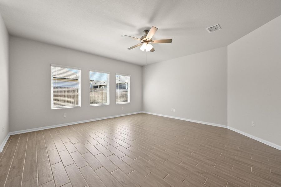 Spacious living area with windows facing the backyard.