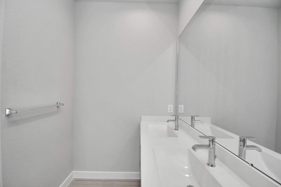 Escape to a spa-like oasis in this primary bathroom. Enjoy a walk-in shower with tile surround, a separate garden tub with custom detailing, and an elegant vanity featuring light countertops, modern hardware, and beautiful recessed lights. Experience luxury and relaxation in every detail.