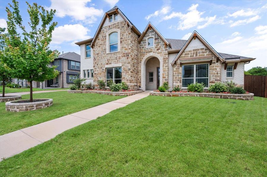 Front exterior of a new home in Wind Ridge, Midlothian, TX, highlighting curb appeal (Image 26). Front exterior of a new home in Wind Ridge, Midlothian, TX, highlighting curb appeal (Image 26).