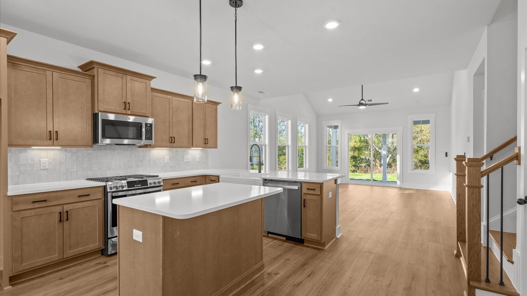 Accomplished kitchen design featuring pendant lighting above a statement island for both prep and gathering Accomplished kitchen design featuring pendant lighting above a statement island for both prep and gathering