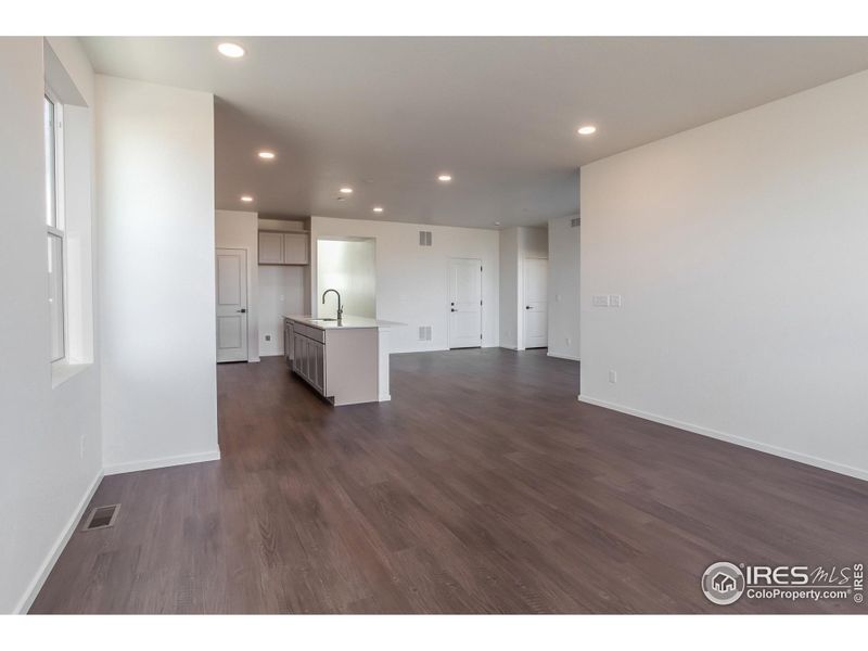 Photos of previously built home. This home features an electric fireplace with stone surround.