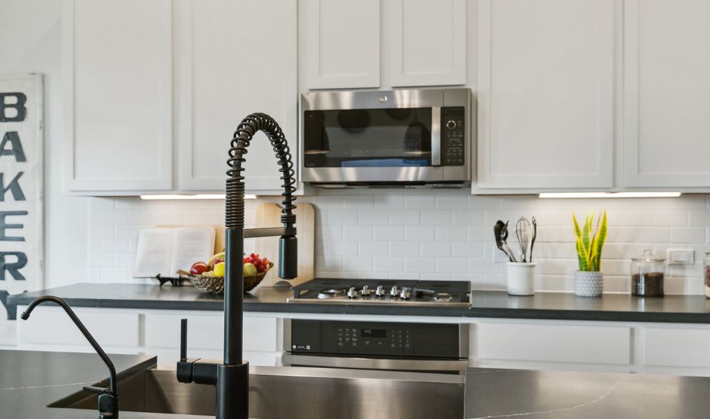 Matte black fixures and stainless steel appliances