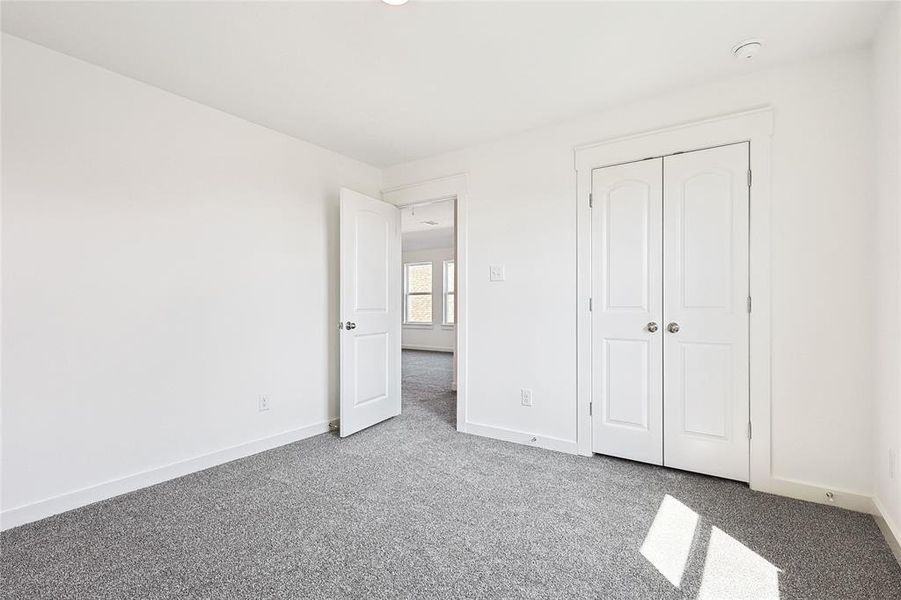 Unfurnished bedroom featuring carpet and a closet