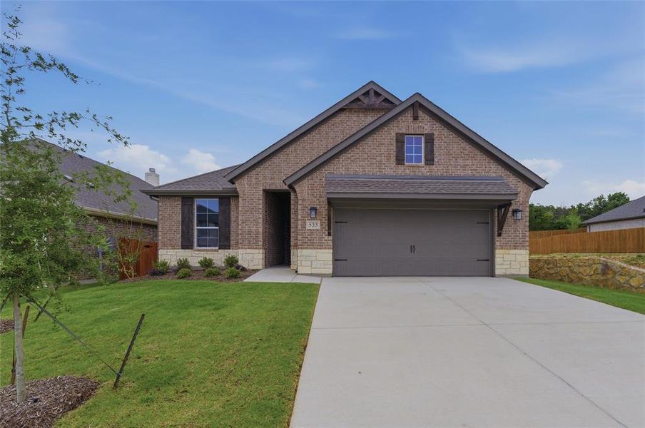 Brick veneer exterior with stone accents and dark brown shutters