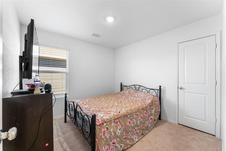 Bedroom featuring light carpet Bedroom featuring light carpet
