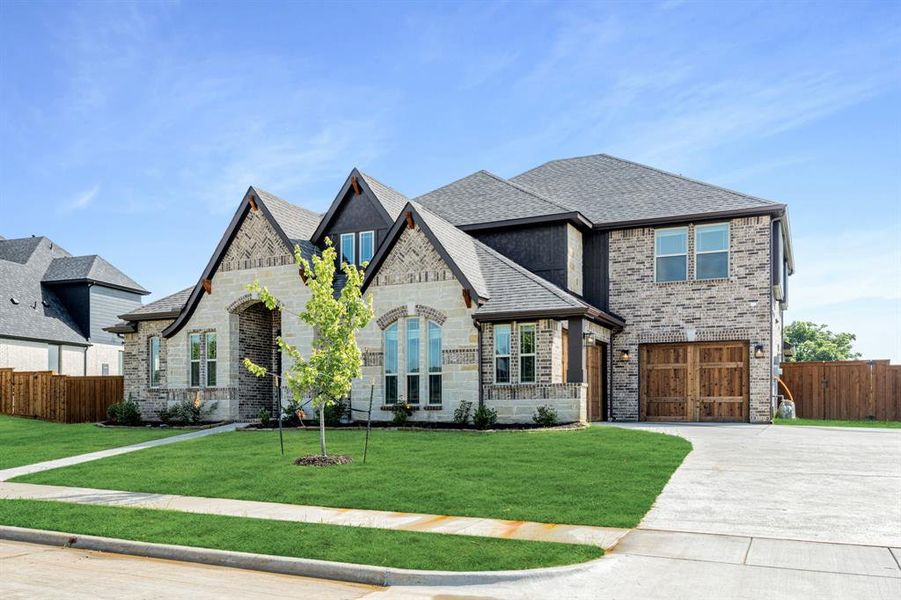 Front exterior of a new home in Rockwood 90, Mansfield, TX, highlighting curb appeal (Image 24). Front exterior of a new home in Rockwood 90, Mansfield, TX, highlighting curb appeal (Image 24).