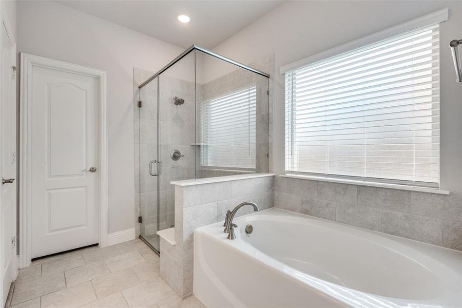 Bathroom with tile patterned flooring and separate shower and tub