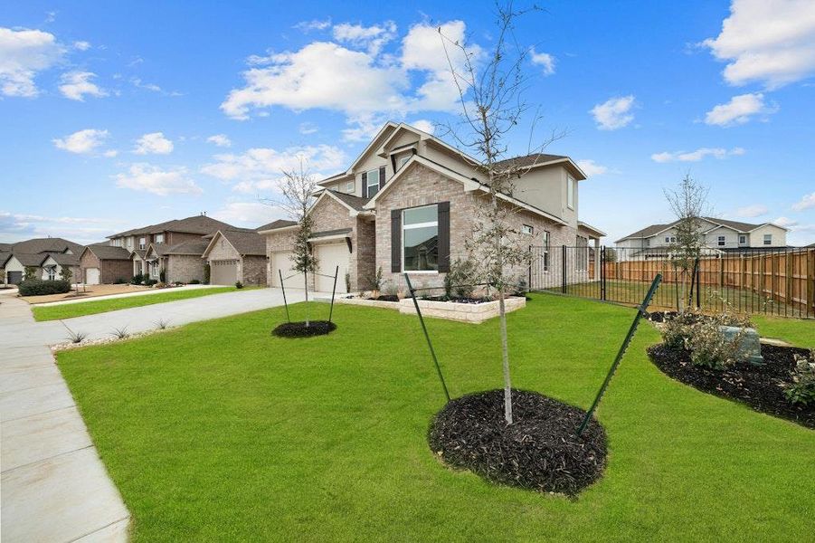 Front exterior of a new home in Santa Rita Ranch, Liberty Hill, TX, highlighting curb appeal (Image 18).