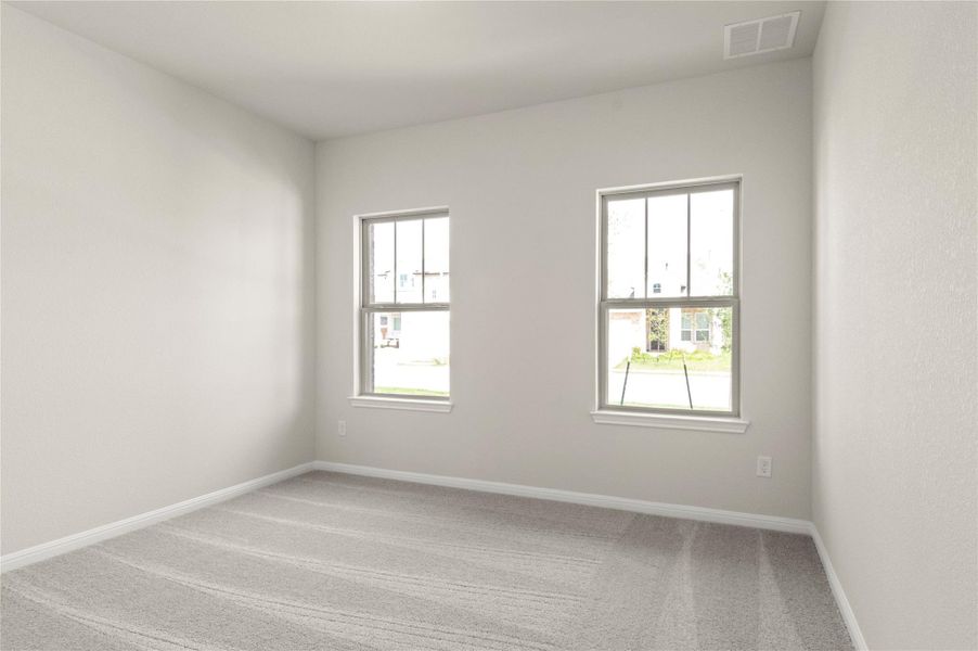 Carpeted spare room featuring plenty of natural light