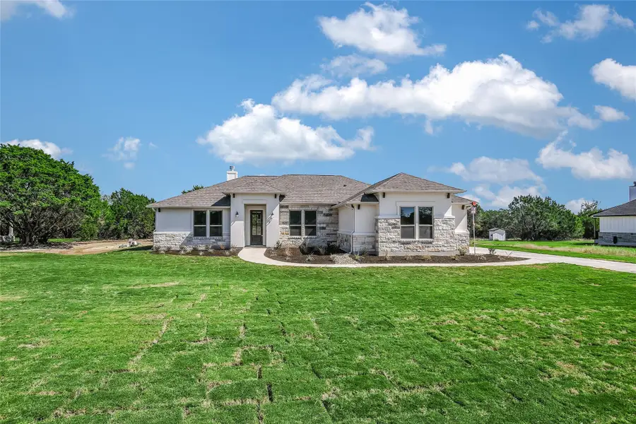 Front exterior of a new home in , Burnet, TX, highlighting curb appeal (Image 1).