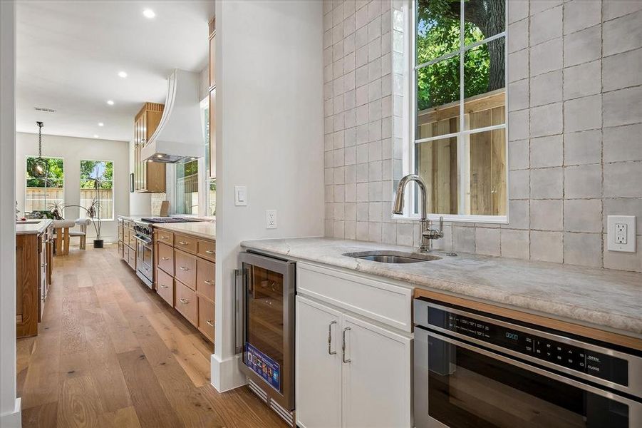 Prep kitchen, dedicated sink, beverage refrigerator, Mizu Silver tile backsplash, built-in microwave Prep kitchen, dedicated sink, beverage refrigerator, Mizu Silver tile backsplash, built-in microwave