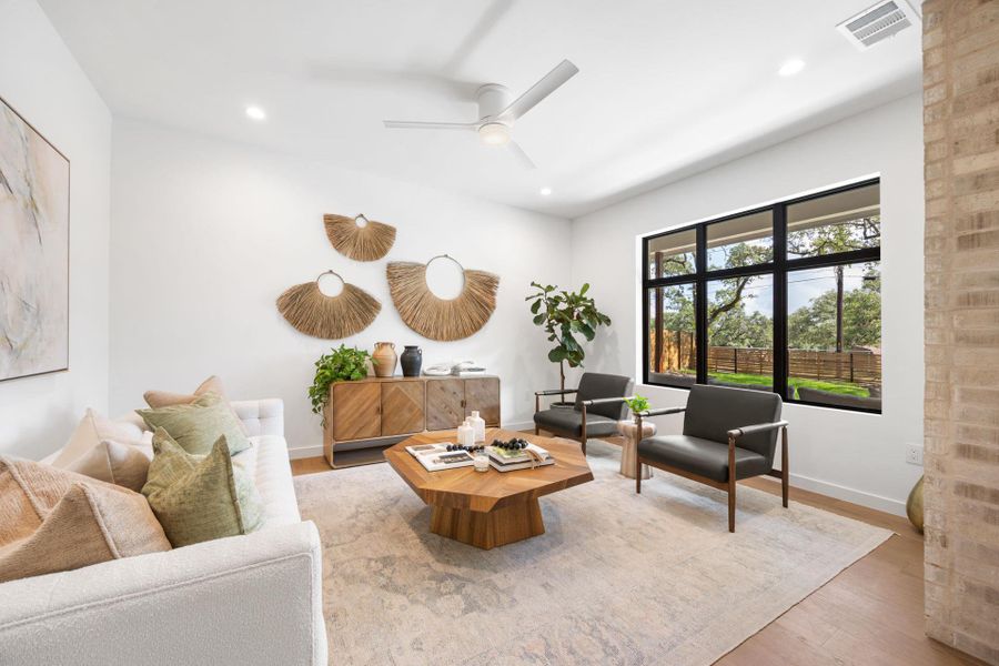 Living area with wood finished floors, recessed lighting, and a ceiling fan