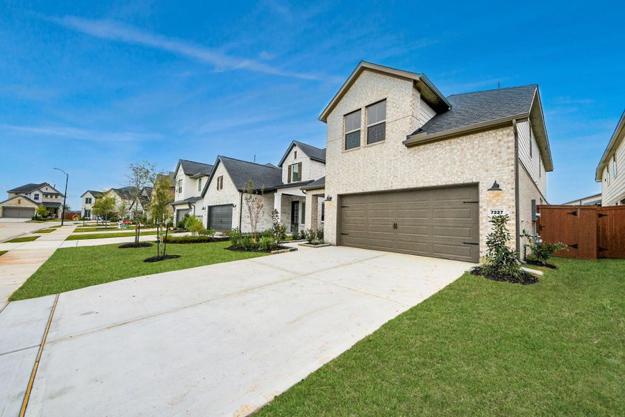 Front exterior of a new home in Elyson, Katy, TX, highlighting curb appeal (Image 22).