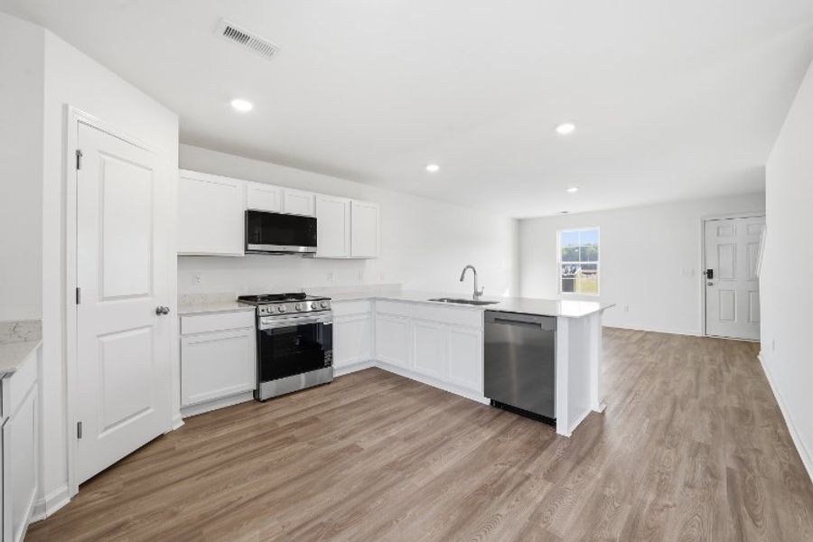A kitchen with white cabinets. A kitchen with white cabinets.