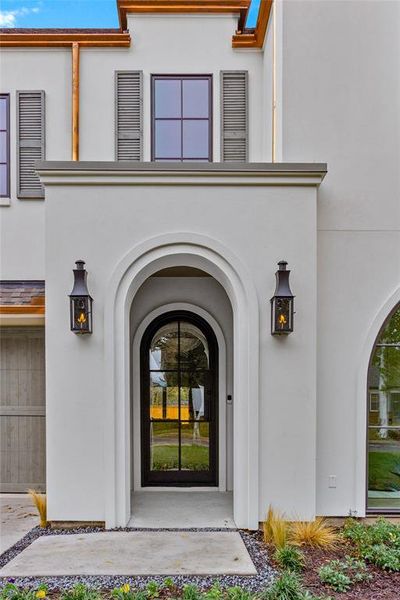 View of exterior entry featuring stucco siding