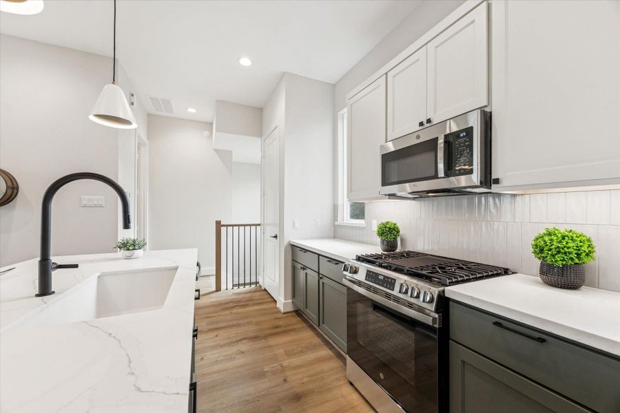 With its two-tone cabinetry, the kitchen brings warmth, color, and a layer of sophisticated contrast to the space.