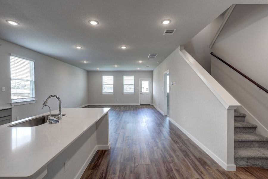 A kitchen with a wood floor.
