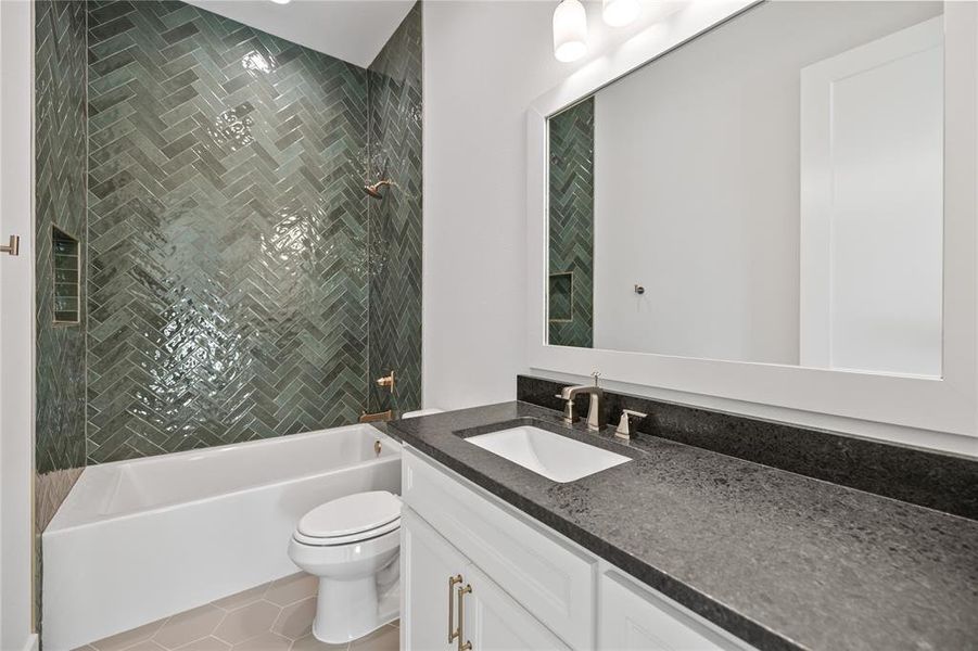 Bathroom featuring vanity, bathtub / shower combination, and light tile patterned floors Bathroom featuring vanity, bathtub / shower combination, and light tile patterned floors