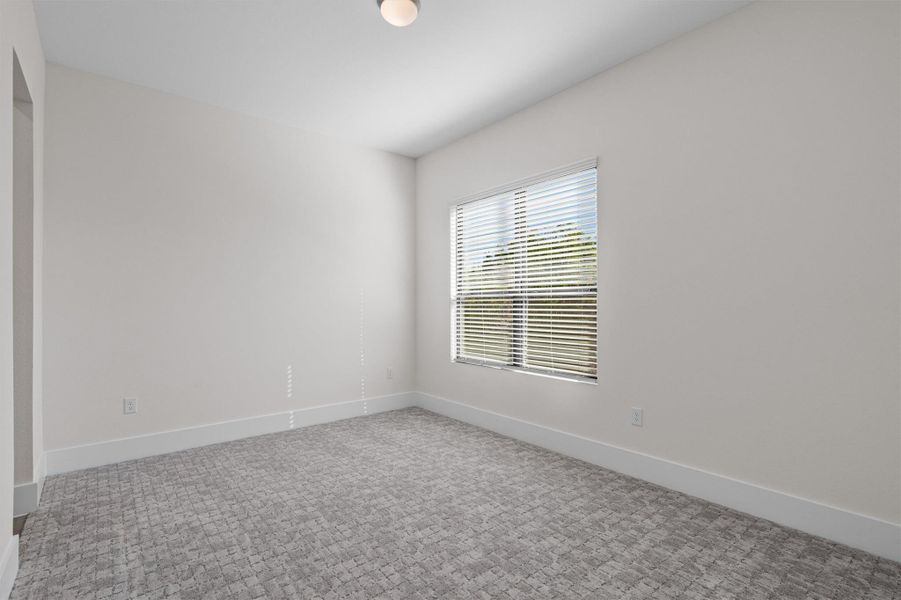 Spare room featuring baseboards and carpet Spare room featuring baseboards and carpet